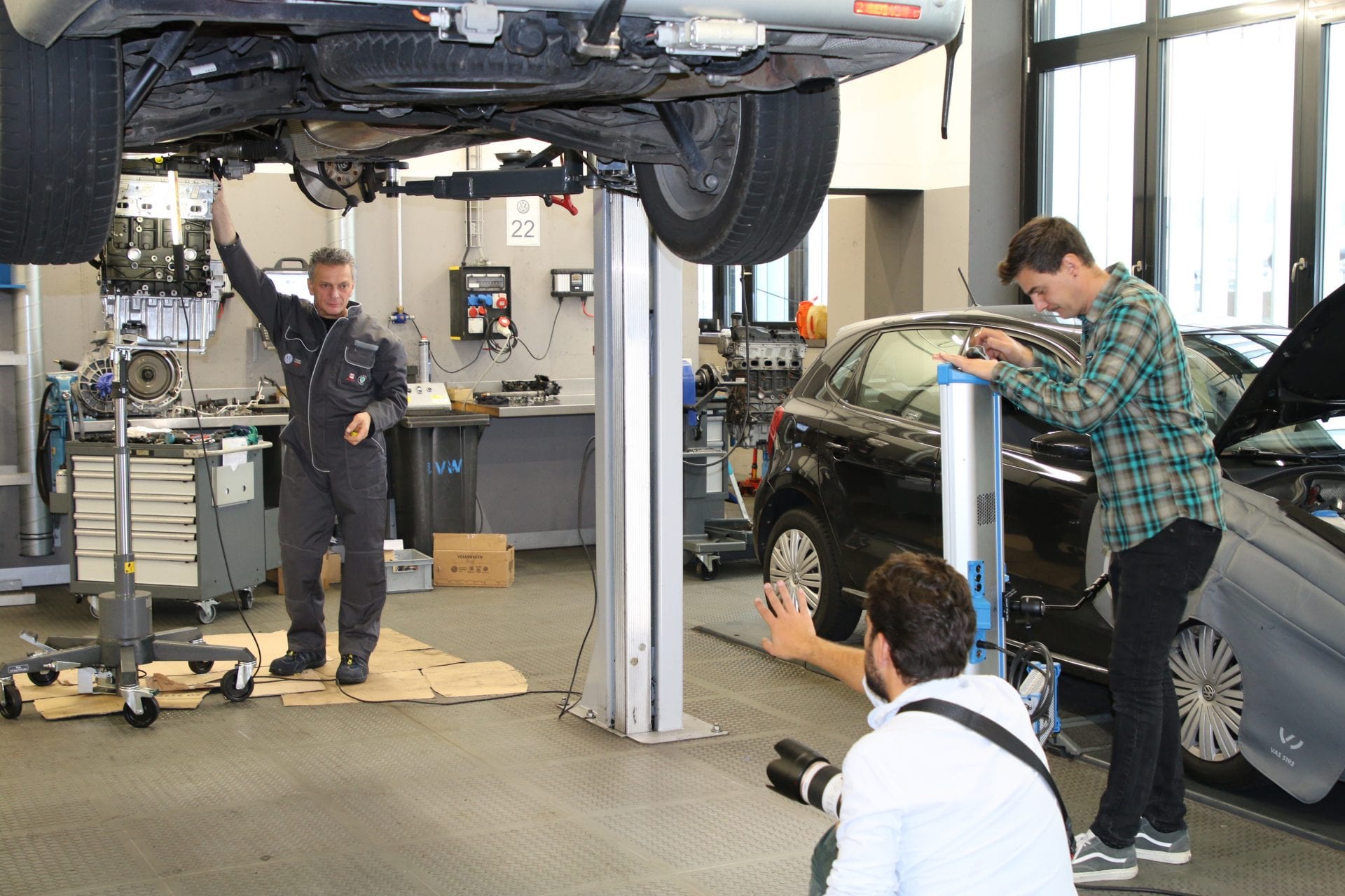 Der Fotograf rückt Georgios Xanthopoulos, Automechaniker VW Werkstatt, ins richtige Licht (Location: AMAG Autowelt Zürich, Shooting «Werkstatt»).